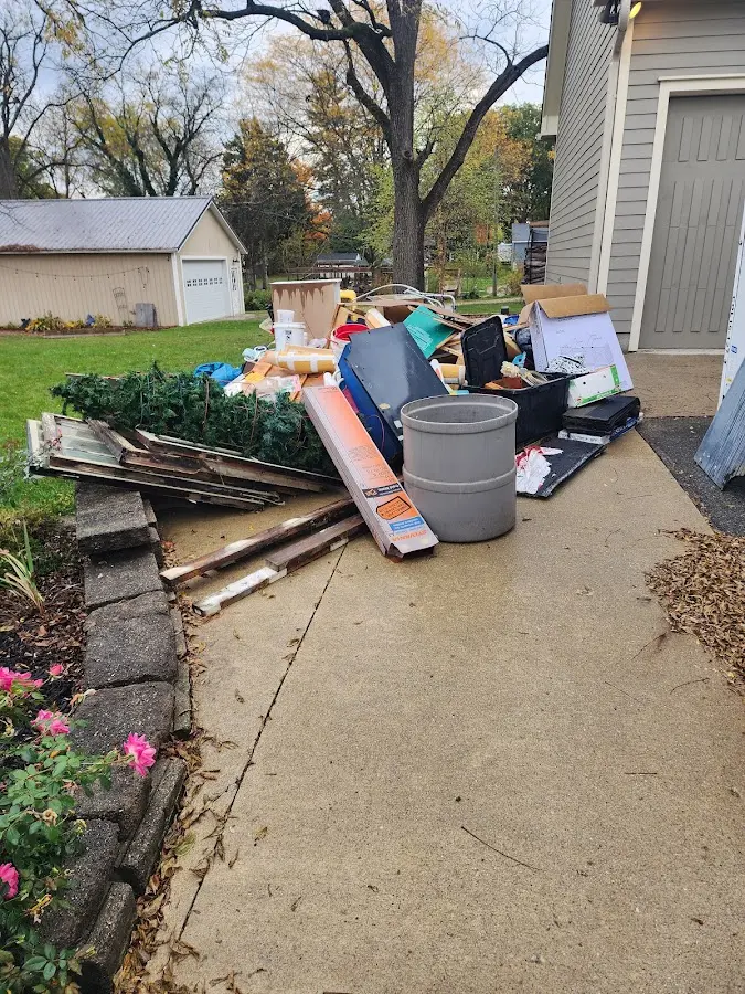 Dumpster being loaded with debris for Residential Dumpster Rental in Essexville